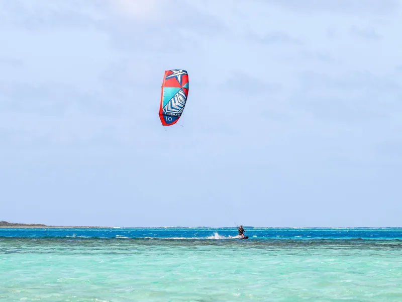 Kitesurfer on a turquoise lagoon